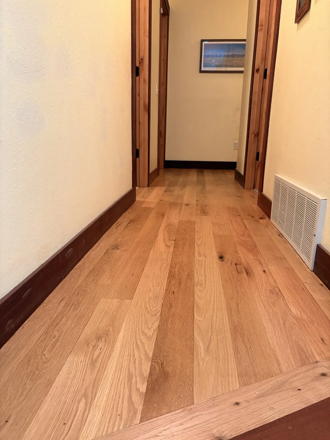 Natural hardwood flooring installed in a Montana home hallway