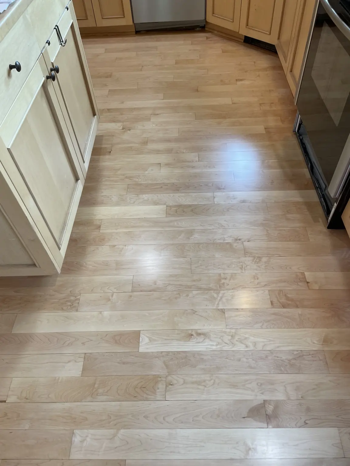 Refinished natural maple kitchen flooring