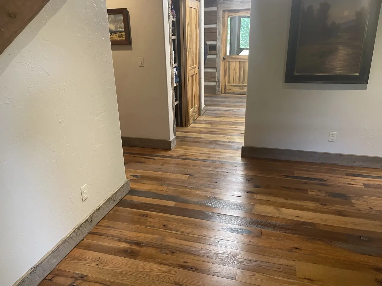 Reclaimed character wood flooring flowing through multiple rooms