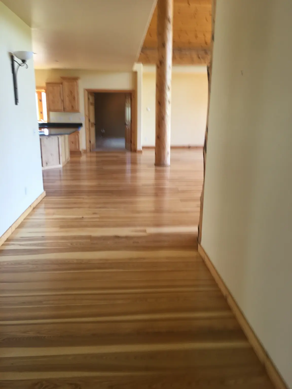 Finished hardwood flooring connecting an open living area